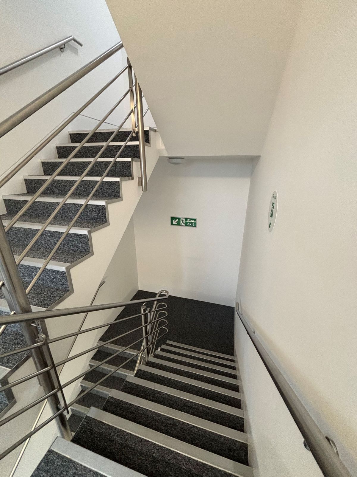 Protected stairwell with fire exit signage — DPK Carpentry & Decorating