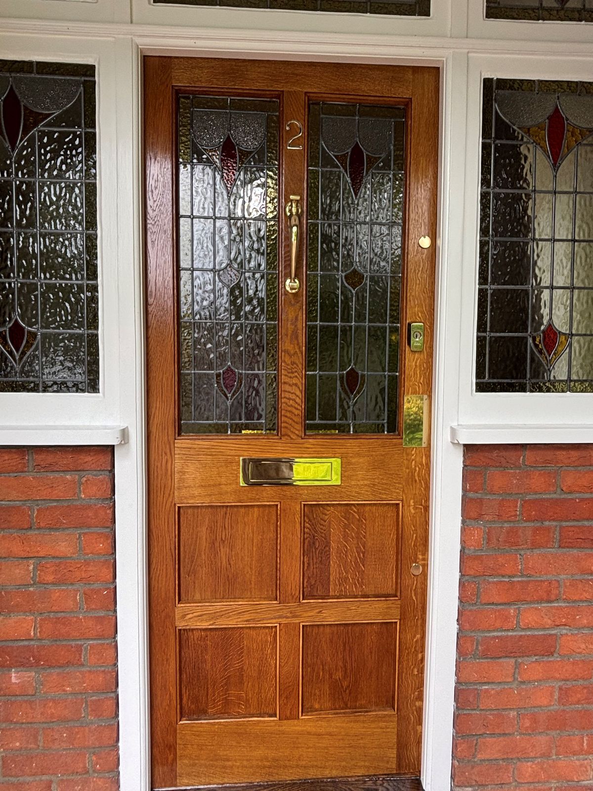 Restored oak front door with stained glass — bespoke joinery by DPK Carpentry & Decorating