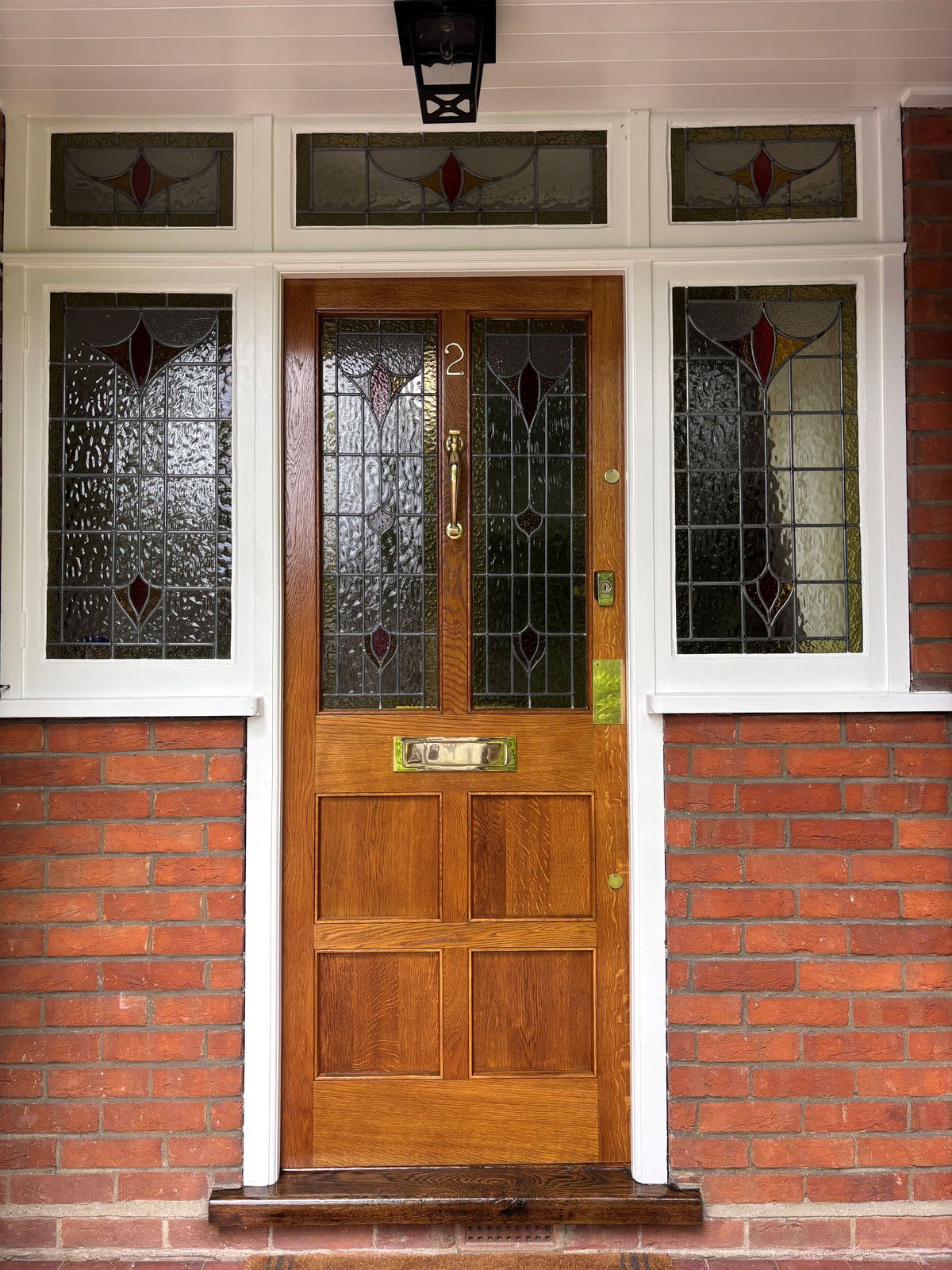 Restored oak entrance door with stained glass panels by DPK Carpentry & Decorating