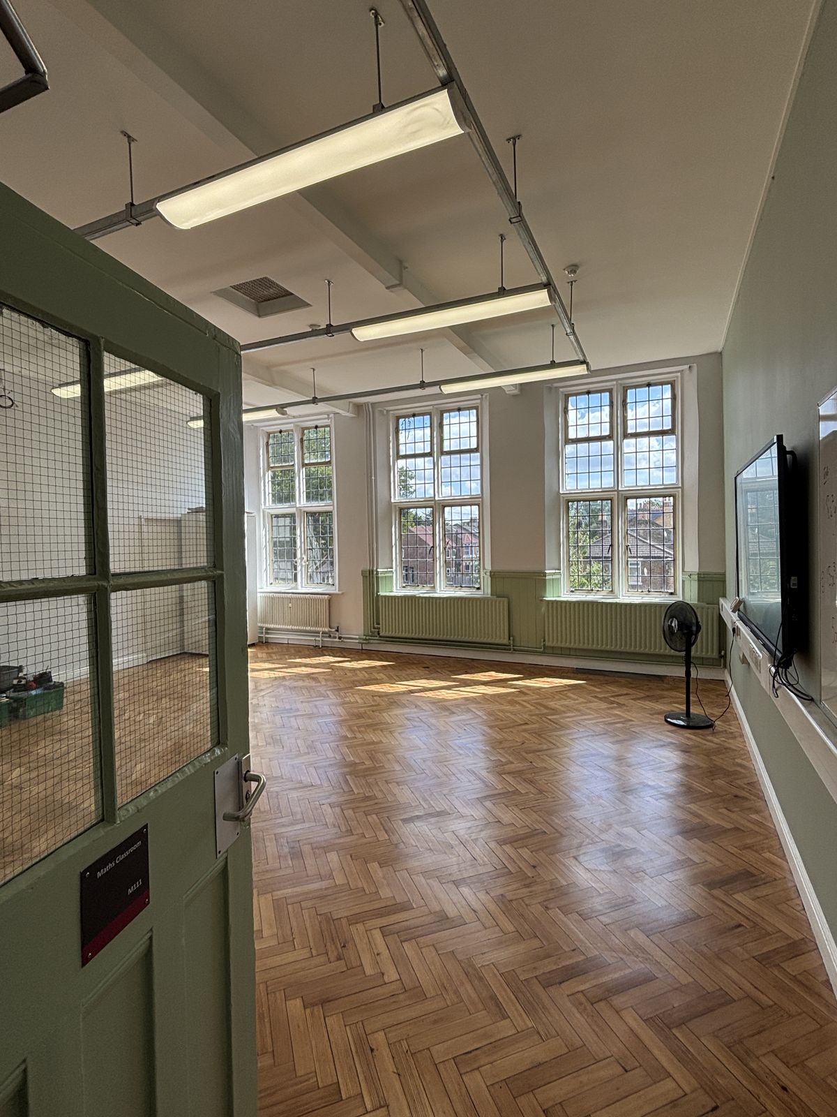 Redecorated school classroom with restored parquet floor by DPK Carpentry & Decorating